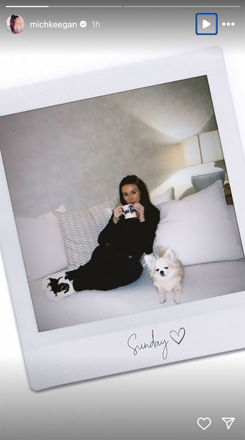 Michelle Keegan cuddled up on the sofa with her dog