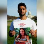 Amit Levy holds up a picture of his sister, Naama, in front of the U.S. Capitol at the March to Bring Them Home on Dec. 8. 2024.