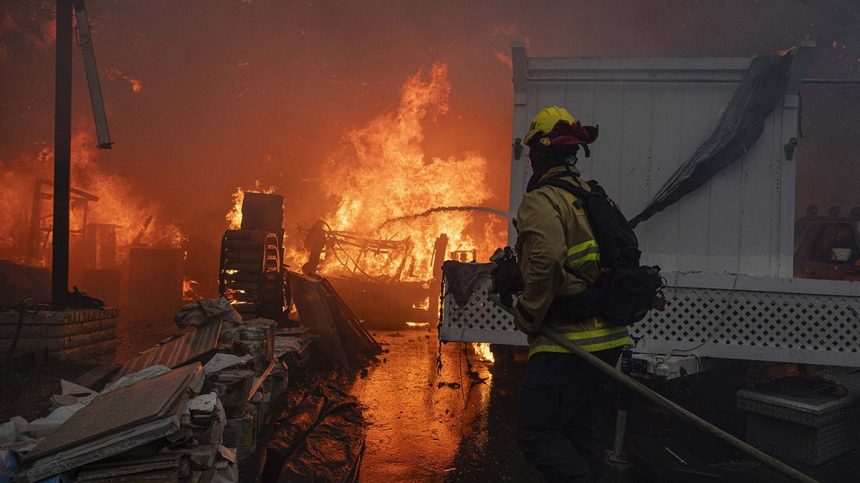 Firefighters in the Palisades at a home