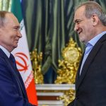 Russian President Vladimir Putin shakes hands with Iranian President Masoud Pezeshkian in Moscow