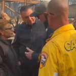 Los Angeles Mayor Karen Bass listens as Gov. Gavin Newsom speaks while touring fire damage in the city Wednesday.