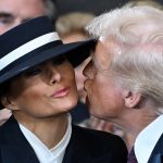 US President-elect Donald Trump kisses Melania Trump as he arrives for the inauguration ceremony