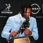 Travis Hunter kisses Heisman Trophy