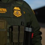 U.S. border patrol agent Alessio Faccin walks along the border fence separating Mexico from the United States near Calexico, California, U.S. February 8, 2017. Picture taken February 8, 2017. REUTERS/Mike Blake - RC166A17F9D0