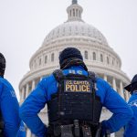 The Dome of the U.S. Capitol Building with U.S. Capitol Police officers