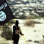 Islamic State militant holds ISIS flag in a desert setting