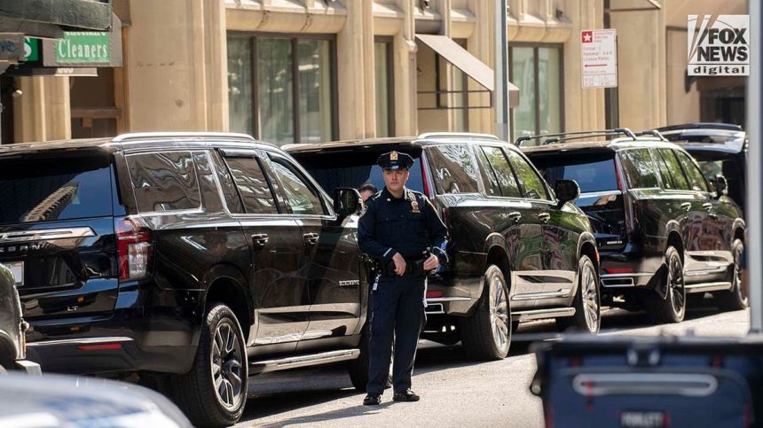 An NYPD officer stands outside parked vehicles relating to the United Nations General Assembly in midtown Manhattan on Wednesday, Sept. 20, 2023.