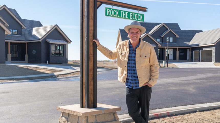 Ty Pennington under Rock the Block street sign