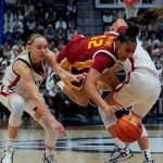 JuJu Watkins, center, is defended by Paige Bueckers and Kaitlyn Chen during the second half of an NCAA women's basketball game at the XL Center on Dec. 21, 2024 in Hartford, Connecticut.