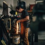 A man works in a black smithing studio