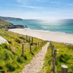 Image may contain Nature Outdoors Scenery Horizon Sky Path Sea Water Trail Shoreline Coast Beach and Grass