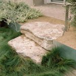 No-mow fescue sod, boulder steps, clay pavers, steel retaining wall and decomposed granite all meet in this entrance to the lawn area.