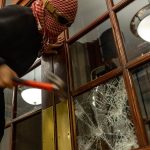 Protester smashing window