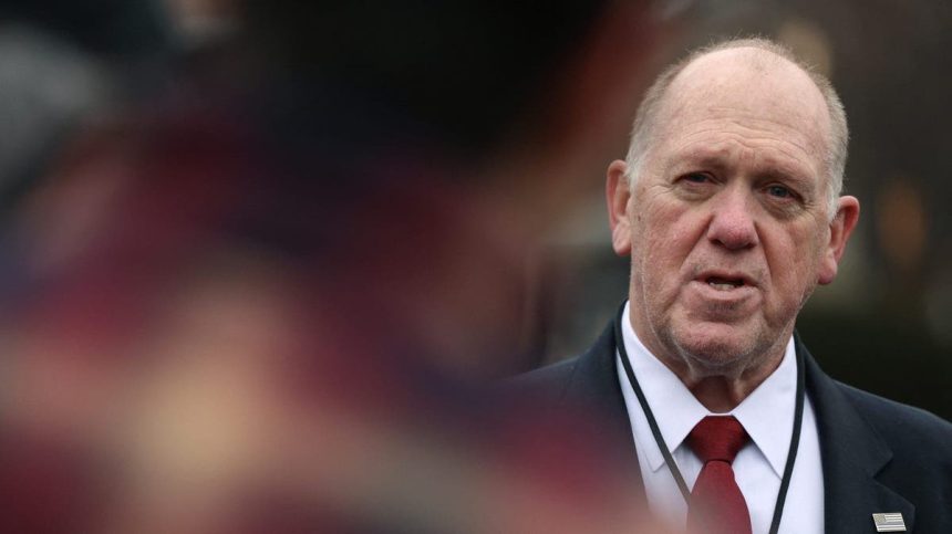 Homan speaks to a man who is out of focus in the foreground