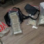 A stack of money and drugs found by the NYPD during a raid