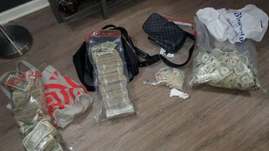 A stack of money and drugs found by the NYPD during a raid