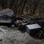 A broken flood wall where mud and floodwaters poured through is seen at Ramsey Mobile Home Park following rain storms that caused flooding on February 17, 2025 in Pikeville, Kentucky. — AFP