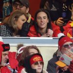 Singer-songwriter Taylor Swift, left, talks with Caitlin Clark of the Indiana Fever during the second half of the AFC Divisional Playoff between the Houston Texans and the Kansas City Chiefs at GEHA Field at Arrowhead Stadium on Jan. 18, 2025 in Kansas City, Missouri.