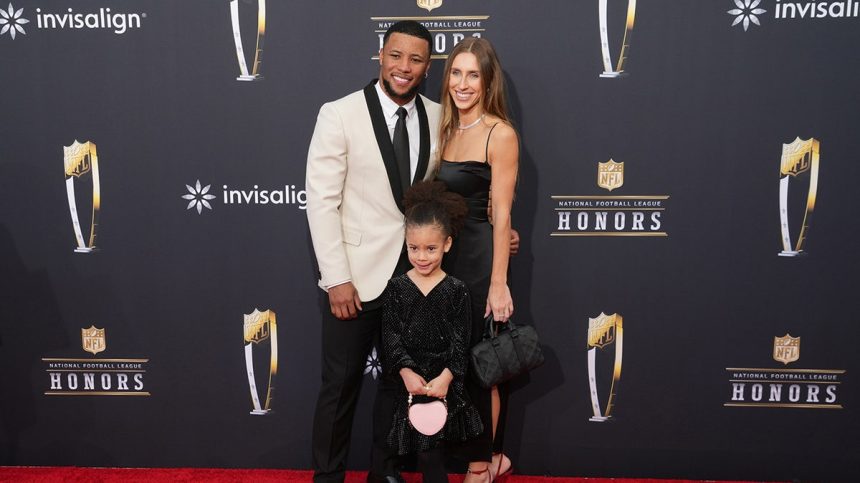 Saquon Barkley, Anna Congdon, and daughter Jada, pose on red carpet