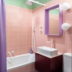 a brightly colored small bathroom in pink, purple, blue and mint green