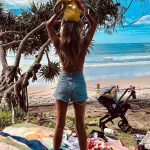 Meredith Hagner poses with son Boone on her shoulders as they look out over beach