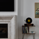 A living room fireplace beside a record player