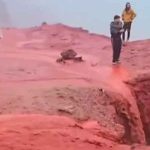 Visitors walk amid red floods caused by heavy rains at Red Beach in Hormuz island of Iran. — Screengrab/Facebook@Meteored