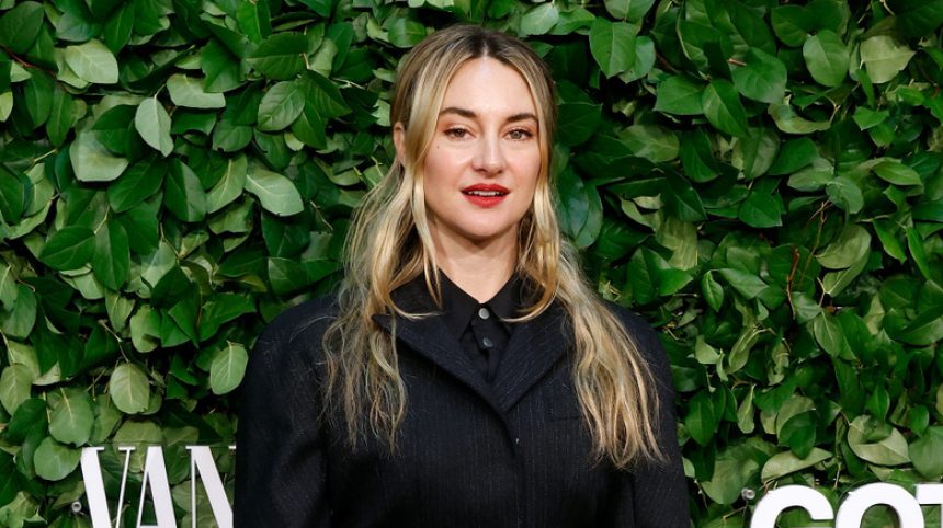 Shailene Woodley wearing black in front of leafy background