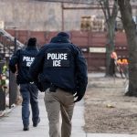 ICE agents walk Chicago street