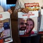 Ofri Bibas Levy holds posters depicting her missing brother Yarden who was kidnapped by Hamas along with his wife and two children