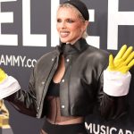 Julia Fox wearing yellow latex gloves at Grammys