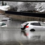 Cars sit in floodwaters