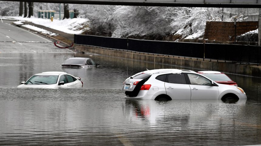 Cars sit in floodwaters