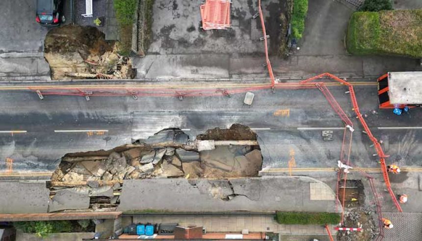 A drone view shows workers looking towards a large sinkhole in Godstone, southern Britain, February 19, 2025. — Reuters