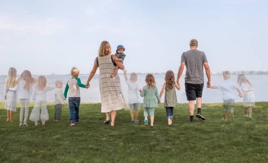 An image of Carmen and her husband Phillip walking with their 11 babies, seven of whom they lost