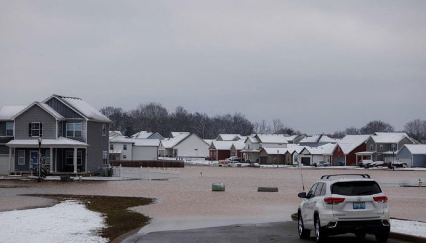 Cars park at the entrance of a flooded housing development after a rain storm in Kentucky, US on February 16, 2025. — AFP