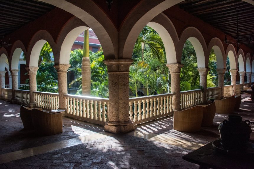 Angled view of the stone colonnade of a monastery cloister in Cartagena Colombia now the hotel Sofitel Legend Santa Clara.