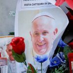 A photo of Pope Francis is placed next to candles and flowers at the base of the statue of the late Pope John Paul II outside the Gemelli Hospital where Pope Francis is admitted for treatment, in Rome, Italy, February 23, 2025. — Reuters