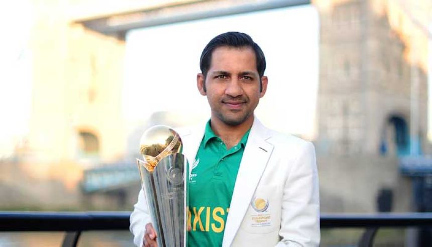 Former Pakistan captain Sarfaraz Ahmed poses with ICC Champions Trophy near the Tower Bridge in London, United Kingdom, on June 19, 2017. — ICC