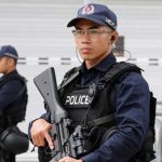 Singaporean policemen stand guard at a media center for the summit between the U.S and North Korea, in Singapore, June 10, 2018. — Reuters