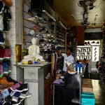 A man waits for customers at a dimmed footwear shop during a nationwide power outage in Galle on February 9, 2025. — AFP