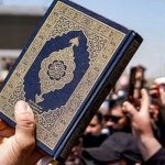 This undated photo shows a person hold a copy of the Holy Quran in his and during a protest demonstration against the desecration of the holy book. — AFP/File