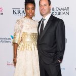 Heather Headley wearing a white dress and her husband Brian Musso, dressed in a suit