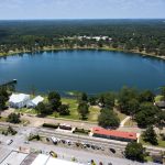 An aerial of a town with a perfectly circular lake