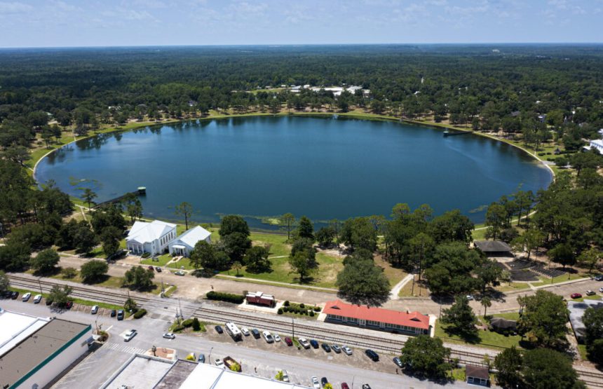 An aerial of a town with a perfectly circular lake