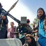 This representational image shows Taliban fighters sit over a vehicle on a street in Laghman province on August 15, 2021. — AFP