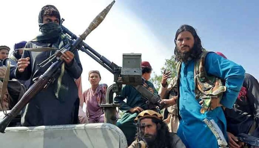 This representational image shows Taliban fighters sit over a vehicle on a street in Laghman province on August 15, 2021. — AFP