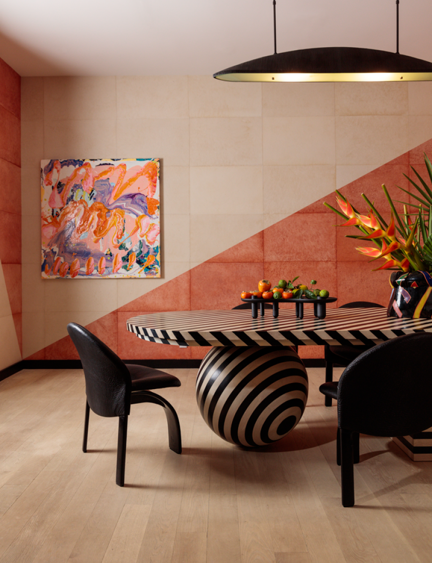 A dining room with a patterned table and bright walls